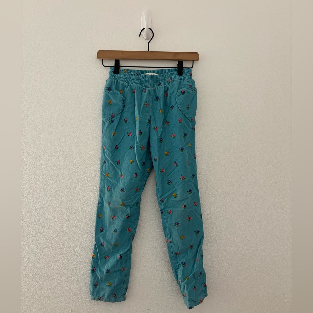 Mini Boden blue floral corduroy pants featuring heart-shaped pockets